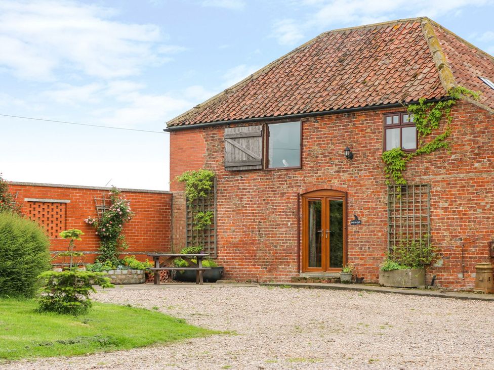 A house with brick walls and a garden at Barn Owl in Louth