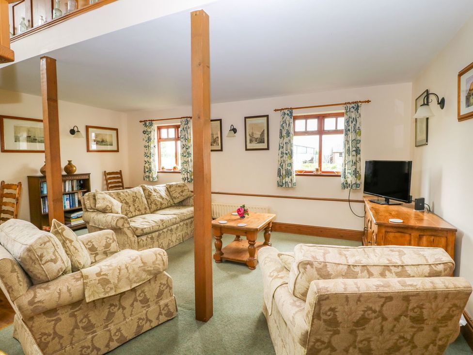 A living room with sofas and a television at Barn Owl in Louth