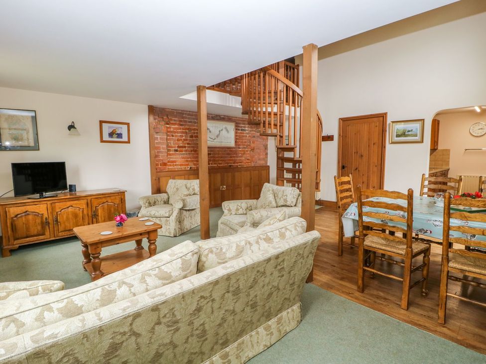 A living room with a sofa and coffee table at Barn Owl in Louth