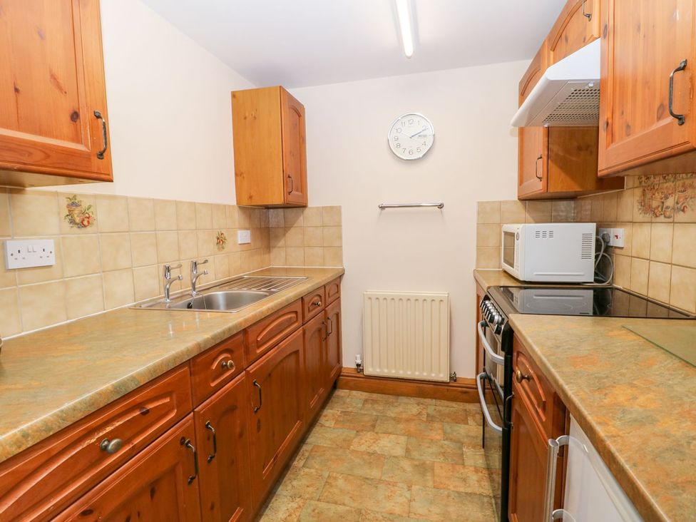 A kitchen with a sink and microwave at Barn Owl in Louth