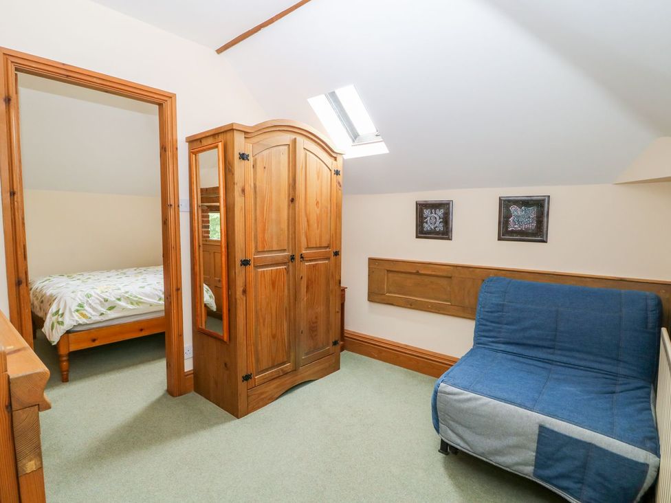 A bedroom with a bed and wardrobe at Barn Owl in Louth