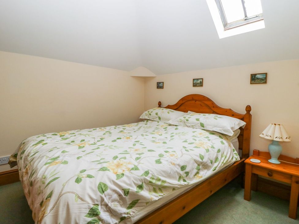A bedroom with a bed and bedside table at Barn Owl in Louth