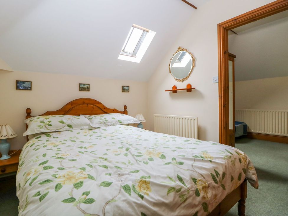 A bedroom with a bed and nightstand at Barn Owl in Louth