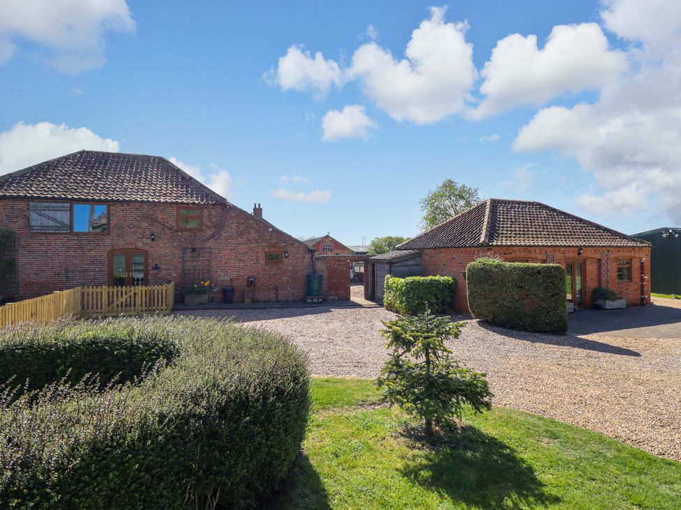 A property exterior with two buildings and a garden at Barn Owl near Louth