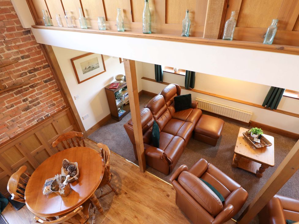 A living room with a sofa and table at Barn Owl near Louth