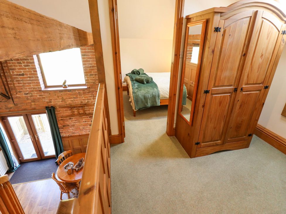 A bedroom with a bed and wardrobe at Barn Owl near Louth