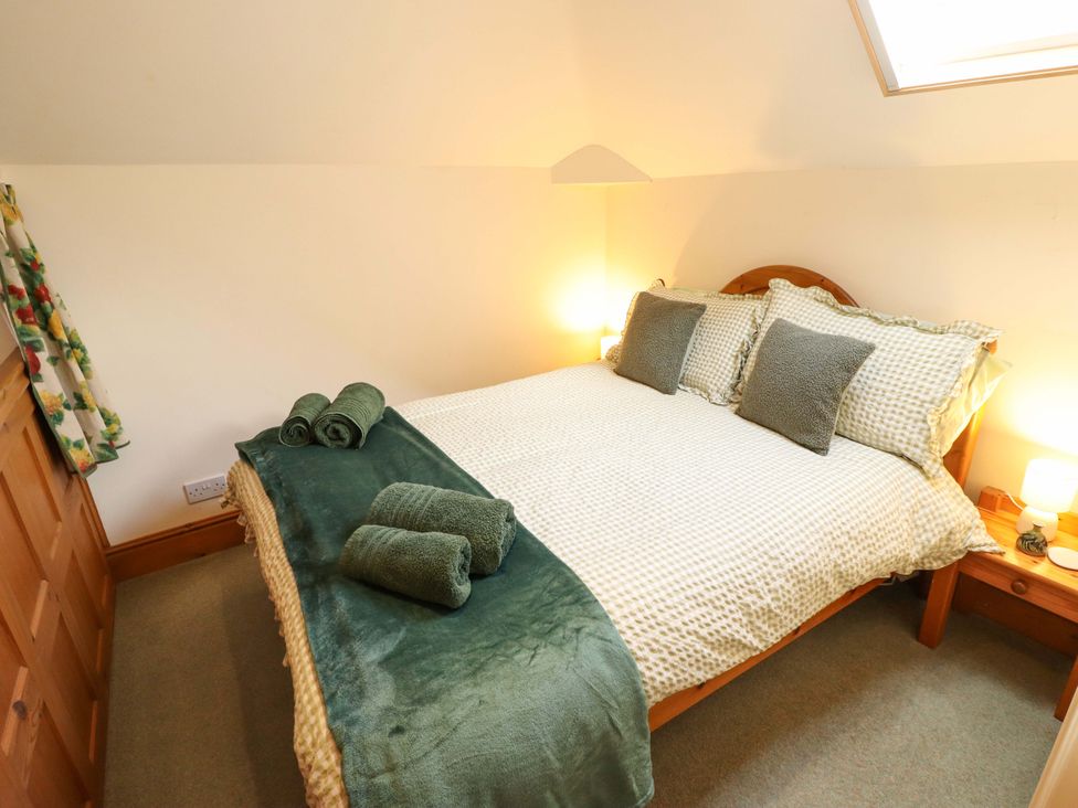 A bedroom with a bed and towels at Barn Owl near Louth