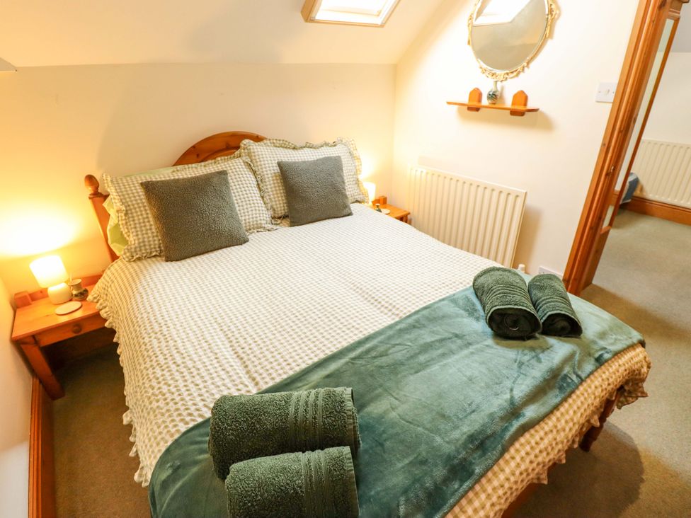 A bedroom with a bed and bedside table at Barn Owl near Louth