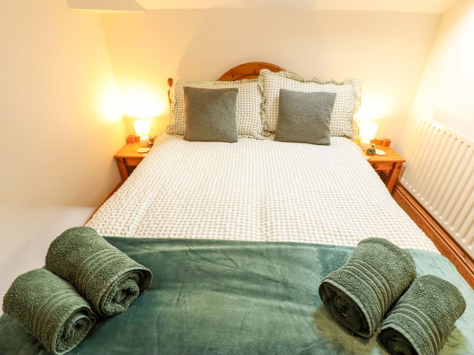 A bedroom with a bed and towels at Barn Owl near Louth