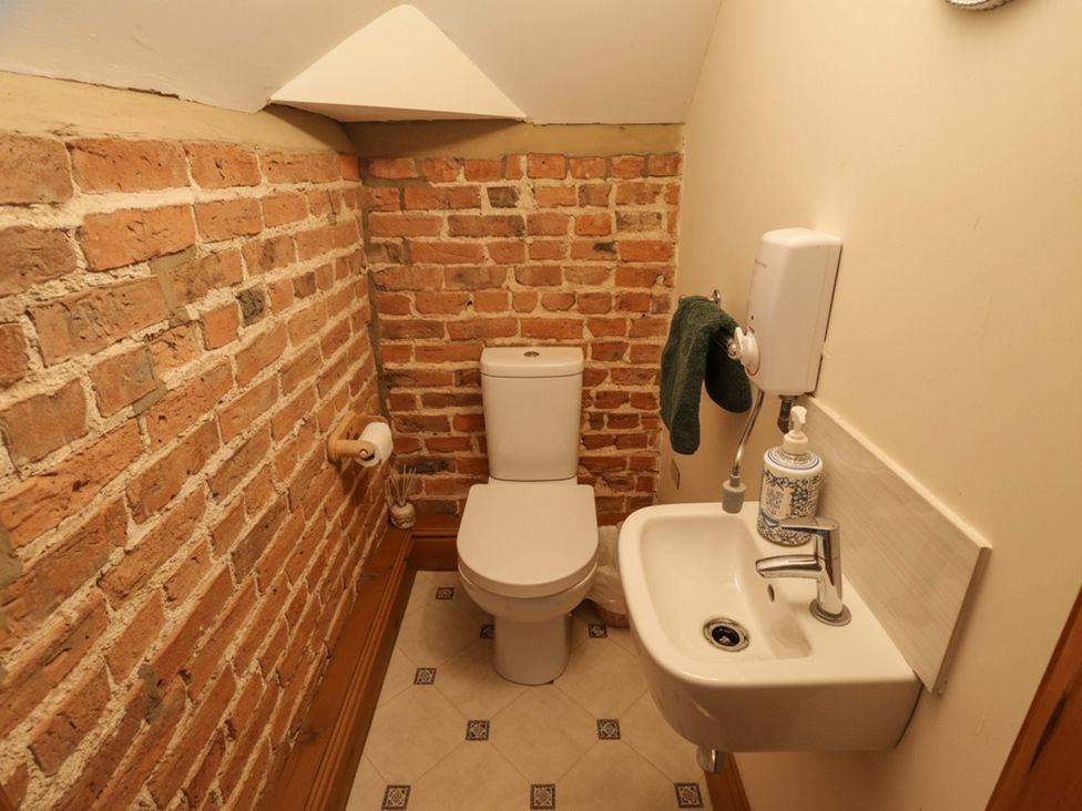A bathroom with a toilet and sink at Barn Owl near Louth