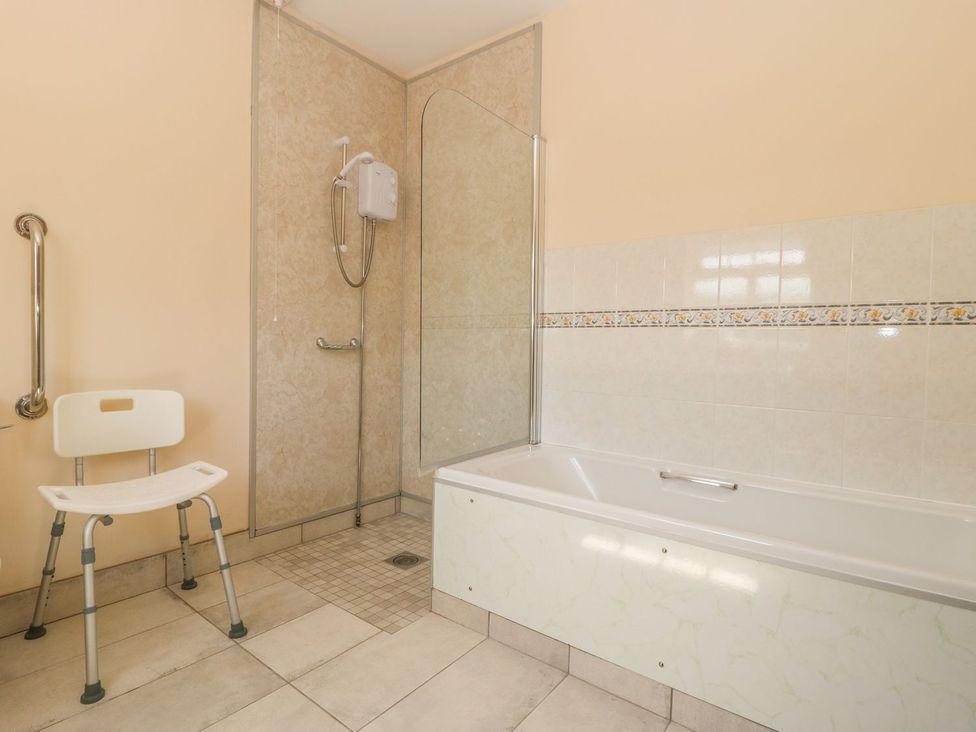 A bathroom with a bathtub and a shower at Kingfisher in Louth