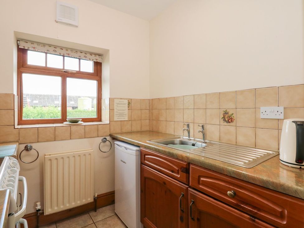 A kitchen with a sink and refrigerator at Ticklepenny in Louth