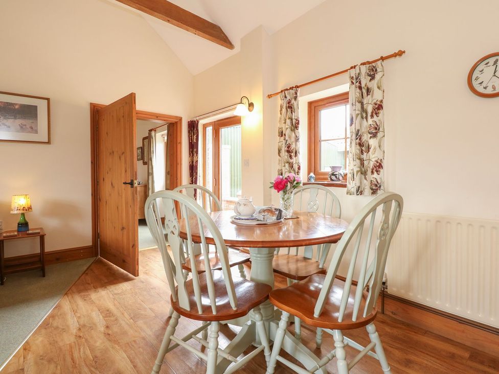 A dining room with a table and chairs at Ticklepenny in Louth