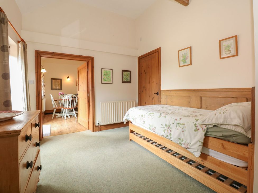 A bedroom with a bed and door leading to another room at Ticklepenny in Louth