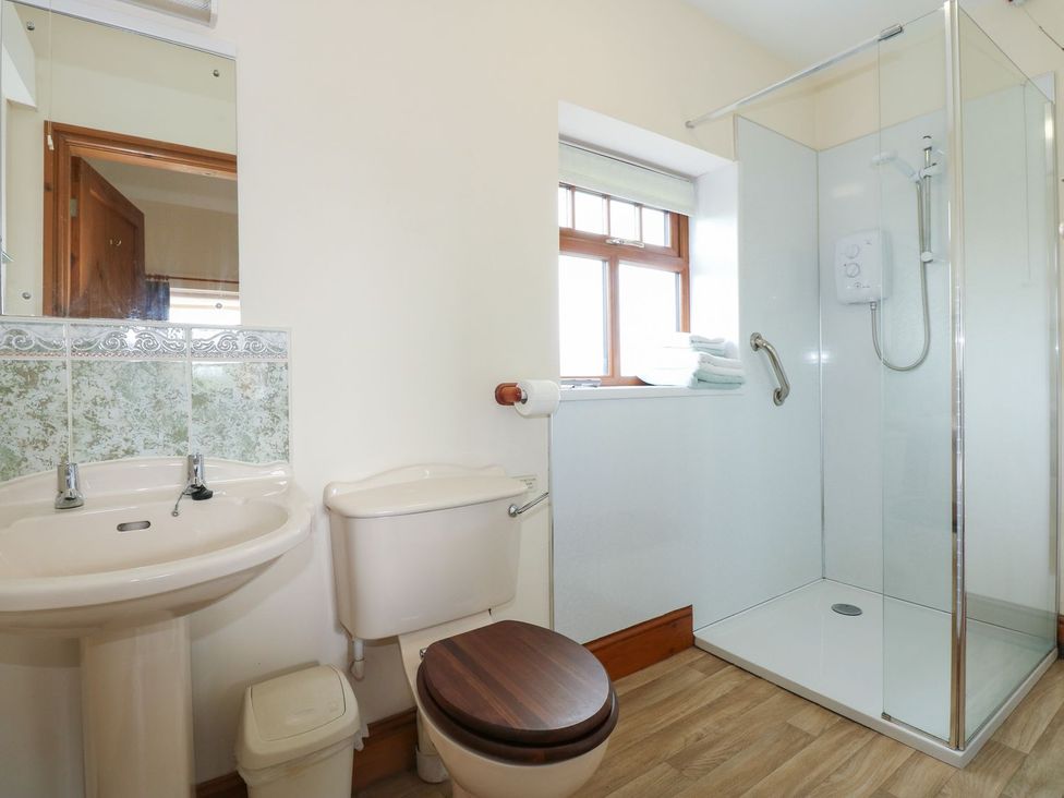 A bathroom with a sink, toilet, and shower at Ticklepenny in Louth
