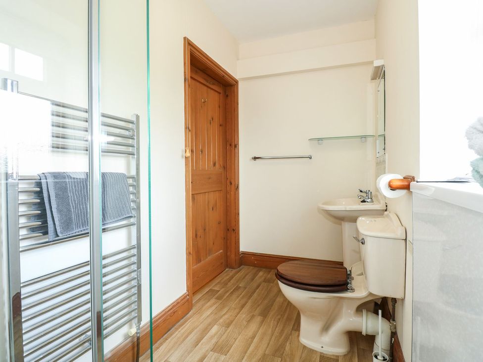 A bathroom with a shower, toilet, and sink at Ticklepenny in Louth