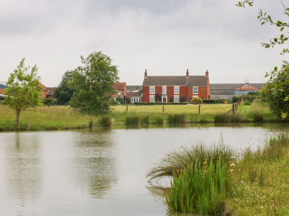 A view of a house by a pond at Ticklepenny in Louth