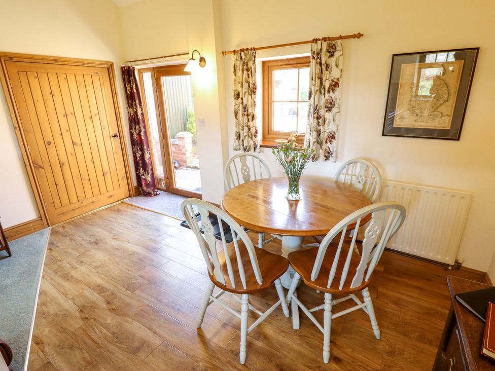 A dining room with a table and chairs at Ticklepenny in Louth