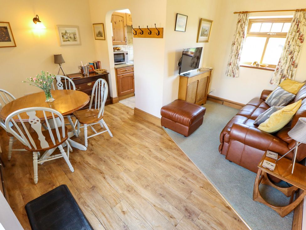 A living room with a sofa and dining table at Ticklepenny in Louth