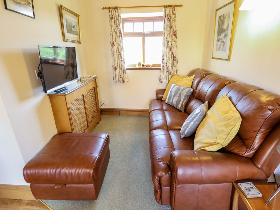 A living room with a sofa and television at Ticklepenny in Louth