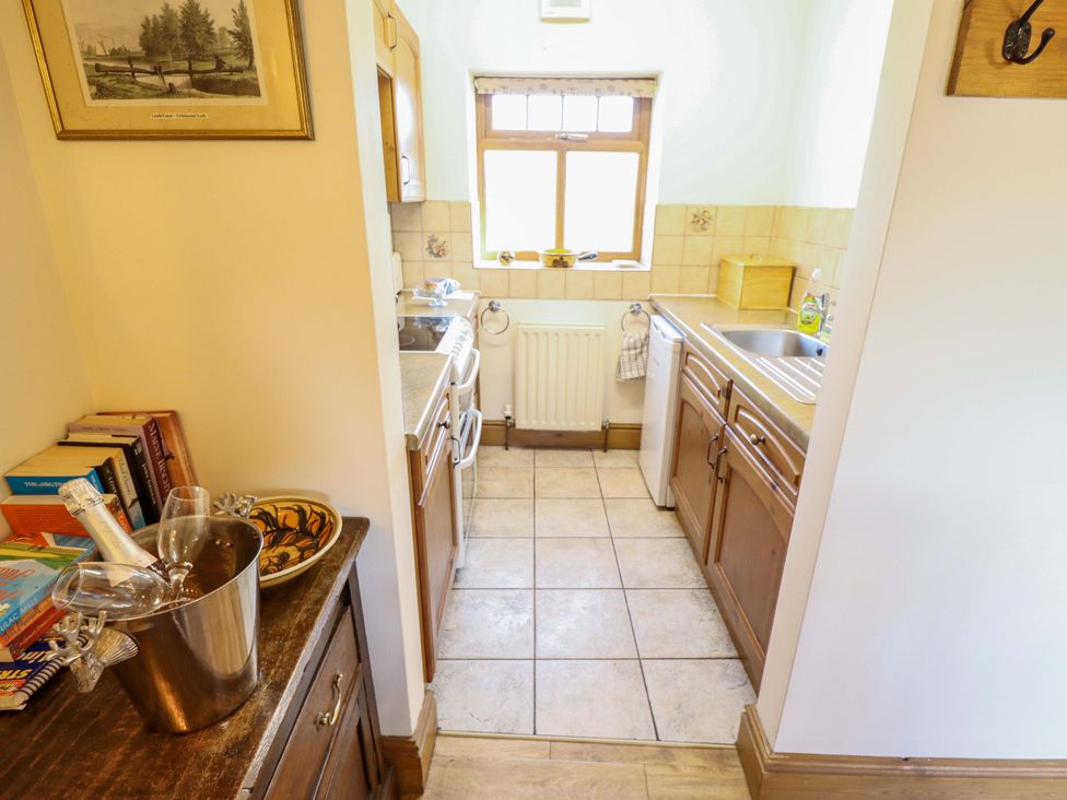 A kitchen with sink, stove, and cabinets at Ticklepenny in Louth
