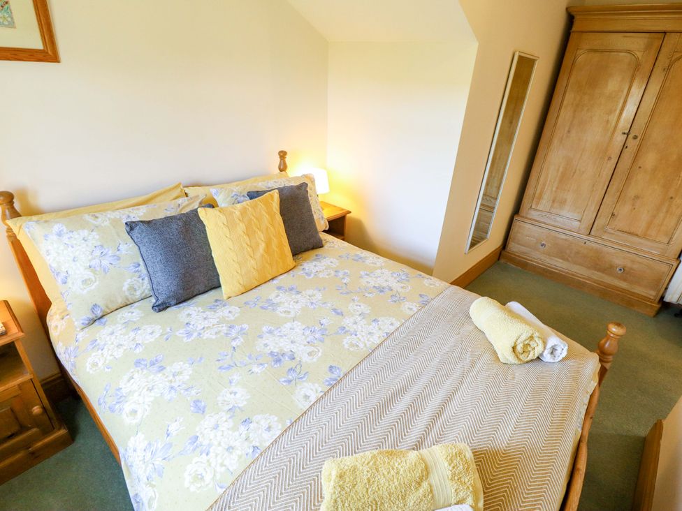 A bedroom with a bed and wardrobe at Ticklepenny in Louth
