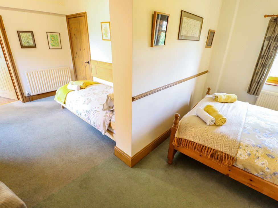 A bedroom with two beds and art on the wall at Ticklepenny in Louth