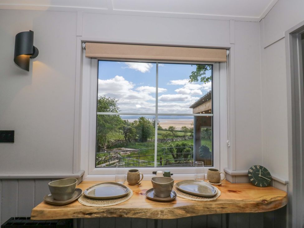 A kitchen window with a view of the outdoors at Little Hut in Grange-Over-Sands