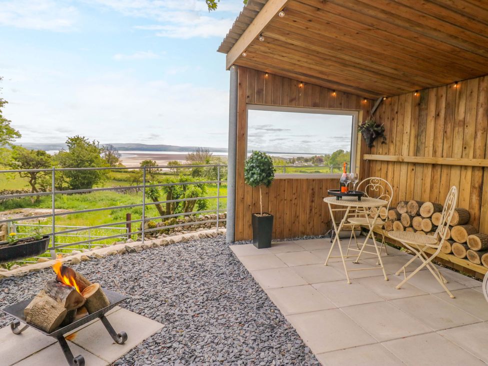 An outdoor area with a fire pit and seating at Little Hut in Grange-Over-Sands