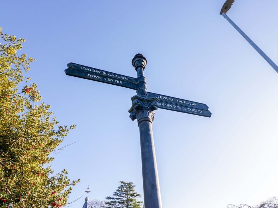 A signpost indicating directions to Town Centre and Leisure Facilities at Little Hut in Grange-Over-Sands