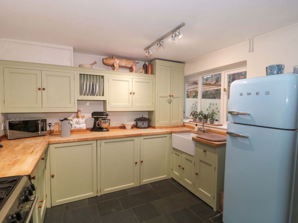 A kitchen with cabinets and appliances at Stones Bakery in Wedmore