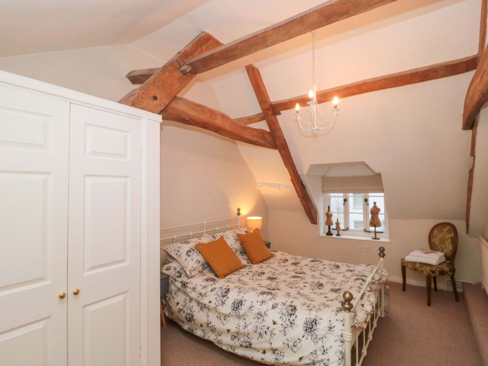 A bedroom with a bed and wardrobe at Stones Bakery in Wedmore