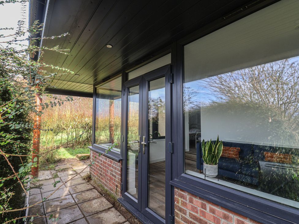 An outdoor area with a door and window at Little Poppes Lawn in Holditch near Hawkchurch