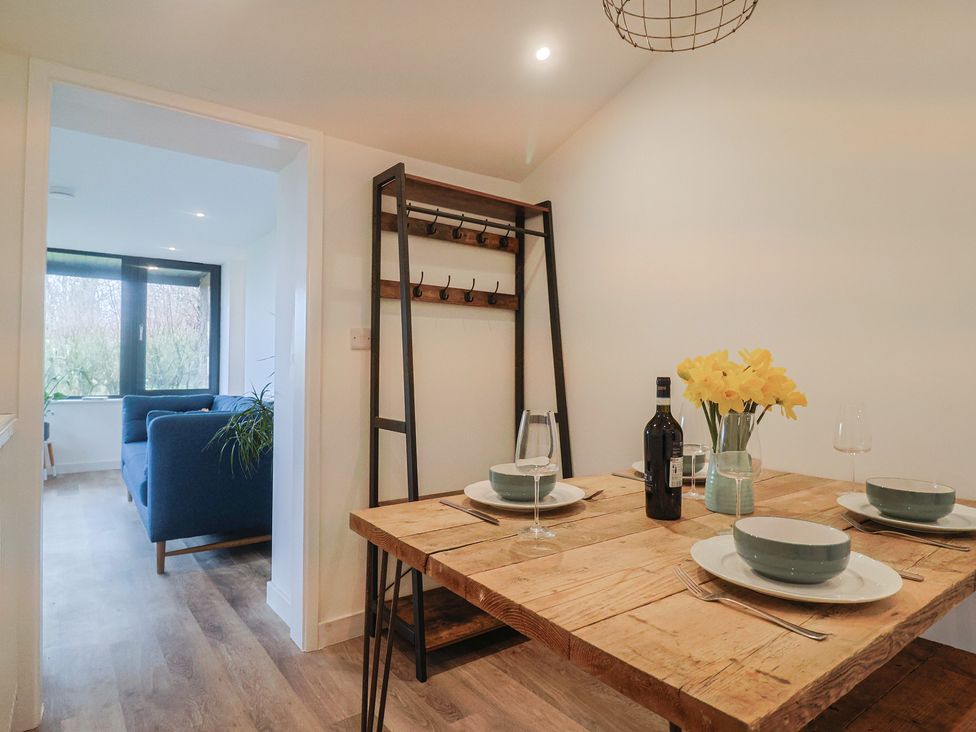 A dining room with a table set for two at Little Poppes Lawn in Holditch near Hawkchurch