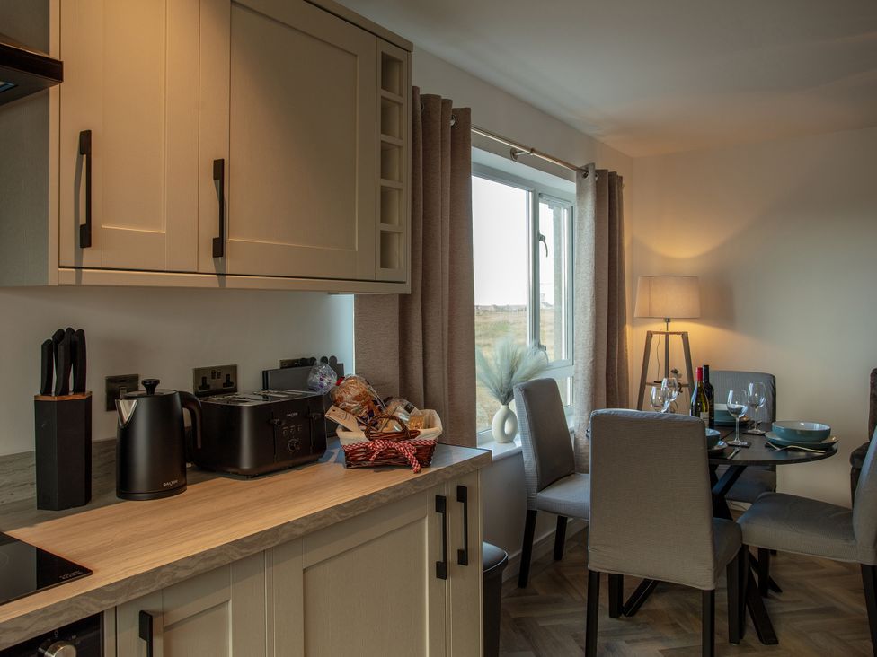 A kitchen with a dining area at 365 South Boisdale Daliburgh, Isle Of South Uist
