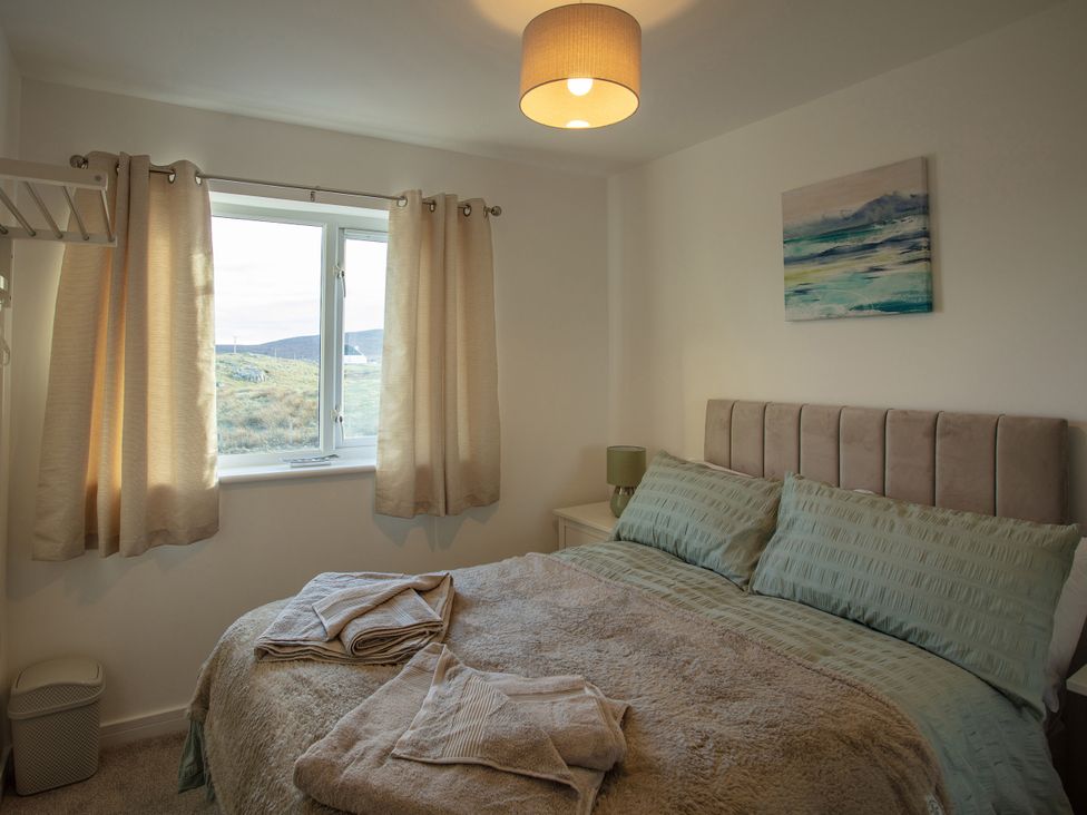 A bedroom with a bed and window at 365 South Boisdale, Daliburgh, Isle Of South Uist