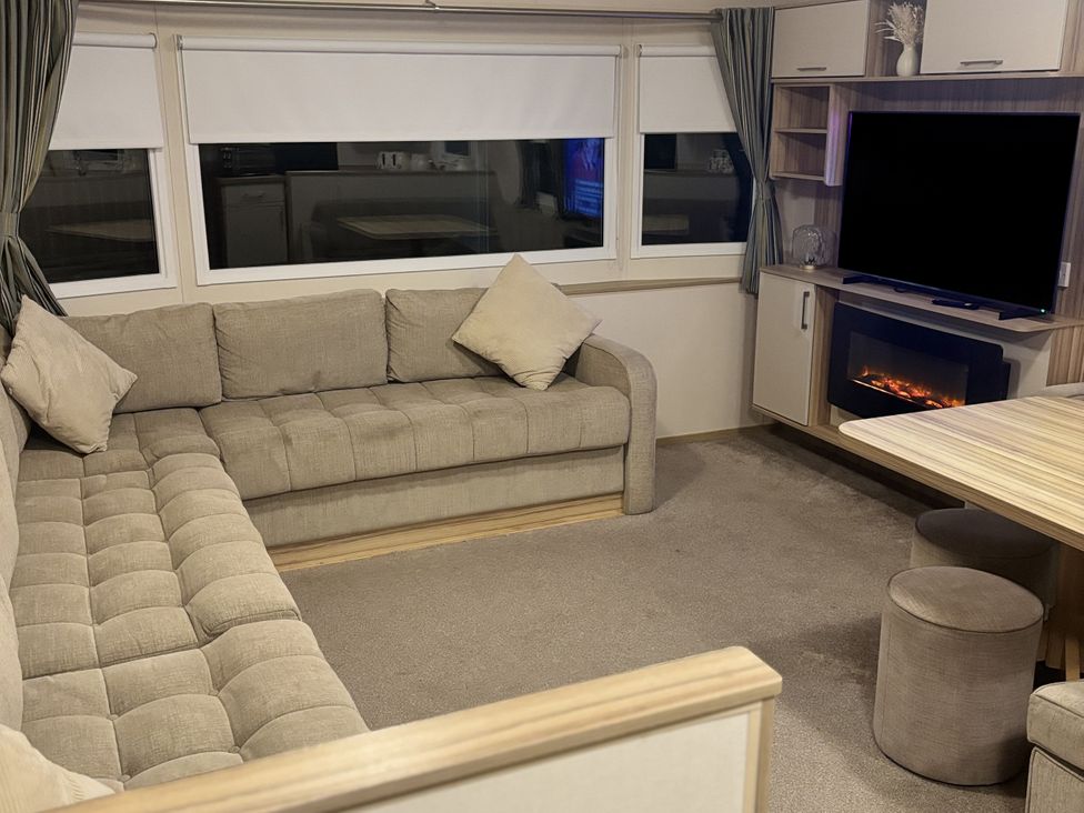 A living room with a sofa and television at 169 Abergele