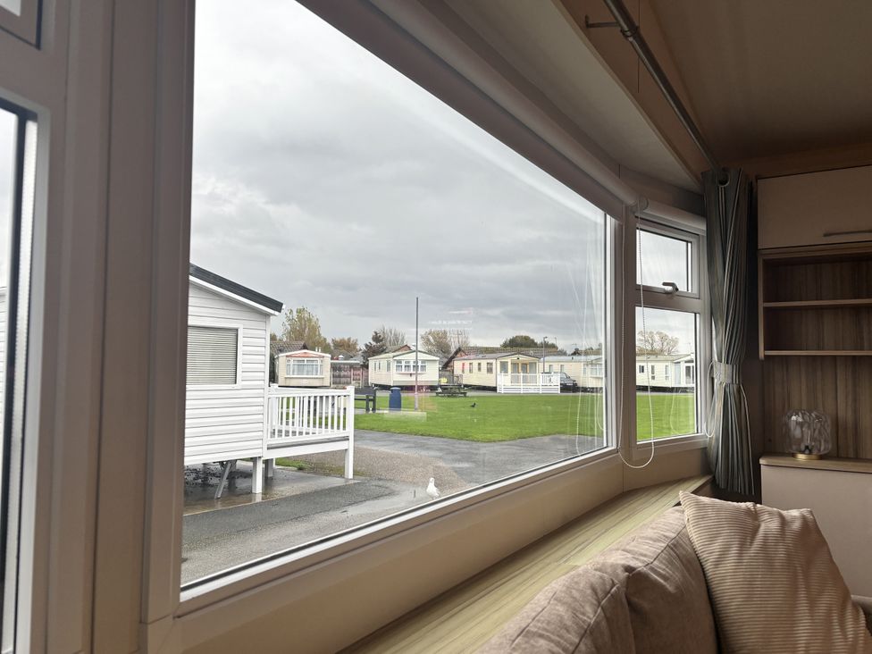A living room view with caravans outside at 169 Abergele