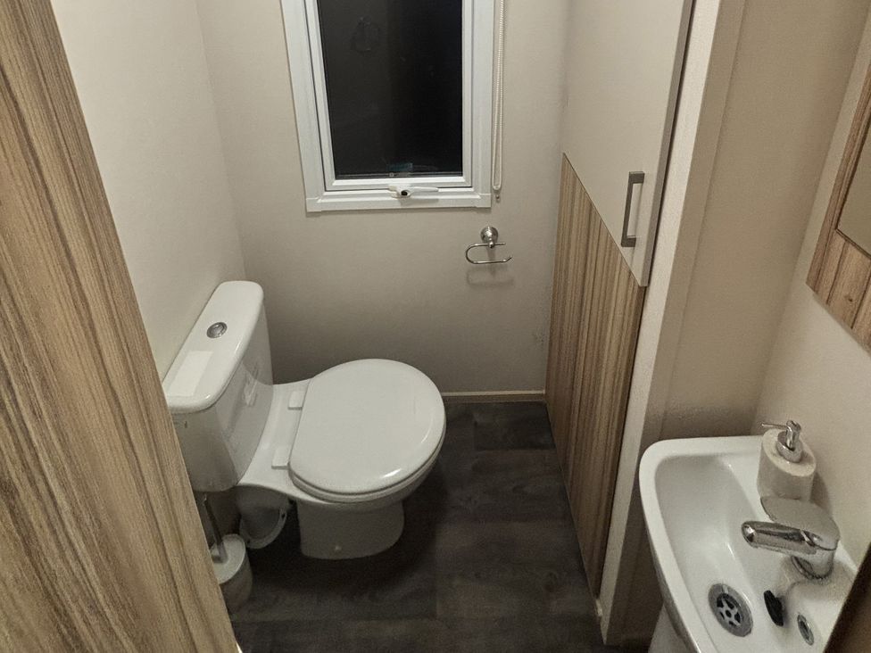 A bathroom with a toilet and sink at 169 Abergele