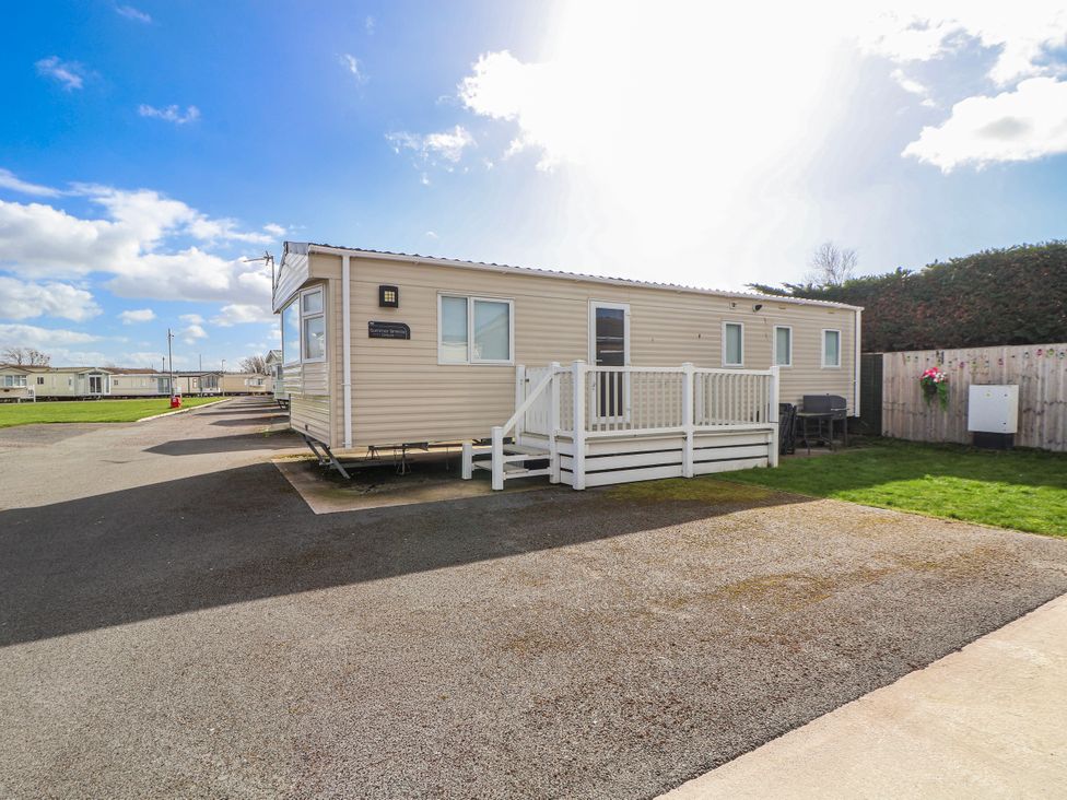 A caravan with a deck in St Michaels Caravan Park - 236 Towyn