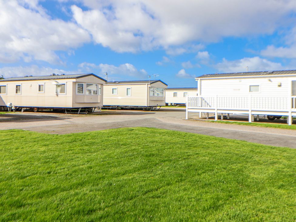 A view of caravans in an outdoor area at St Michaels Caravan Park - 236 Towyn
