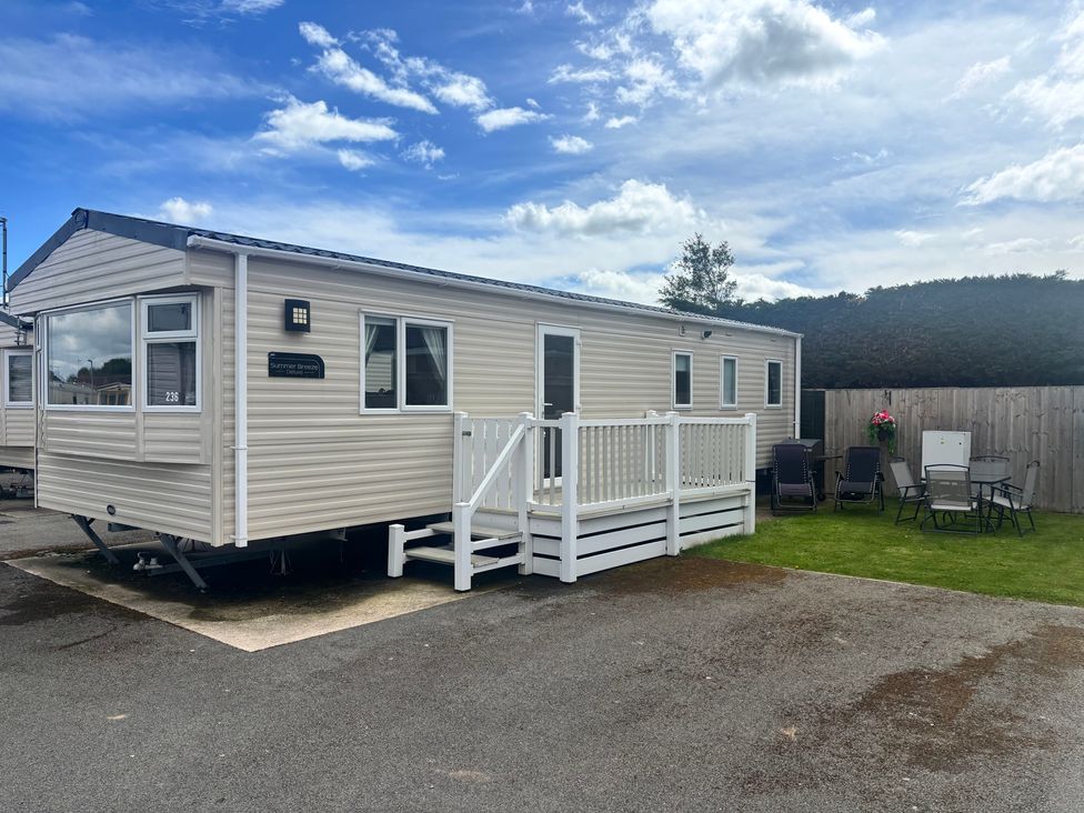 A caravan with seating outside at The Beachside Hideout - St Michaels and Browns Caravan Park in Towyn