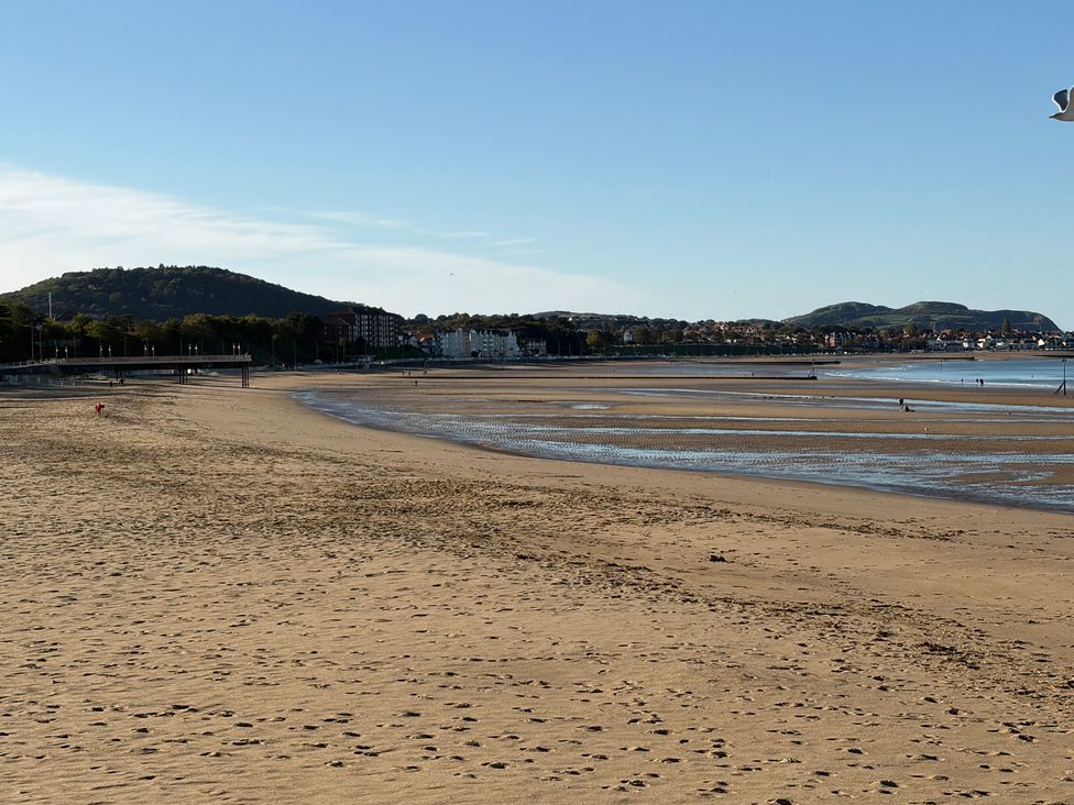 A beach with sand and water at The Beachside Hideout - St Michaels Caravan Park in Towyn