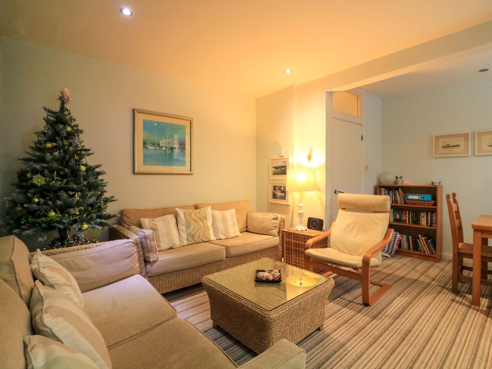 A living room with a sofa and christmas tree at Smugglers Cove in Dartmouth