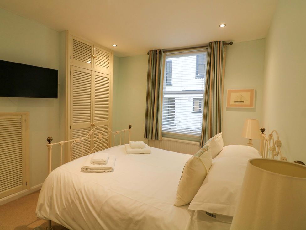 A bedroom with a bed and television at Smugglers Cove in Dartmouth