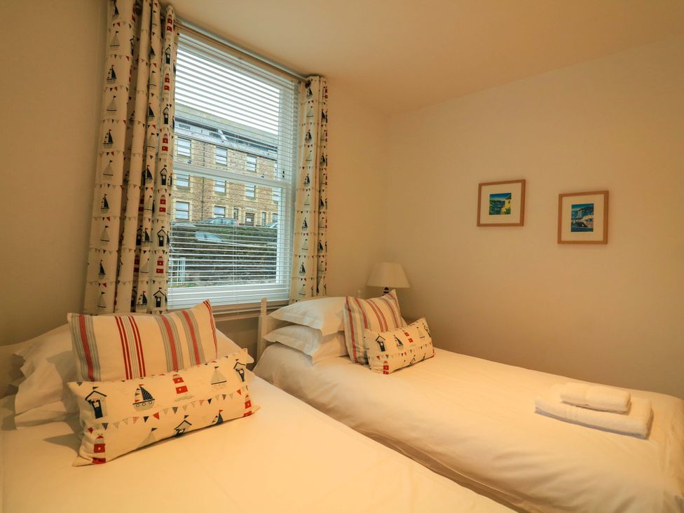 A bedroom with two beds and a window at Smugglers Cove in Dartmouth