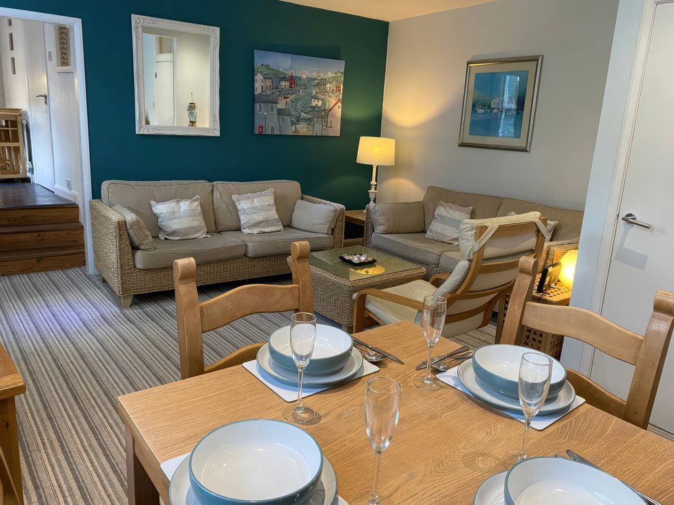 A living room with seating and a dining area at Snugglers Cove in Dartmouth