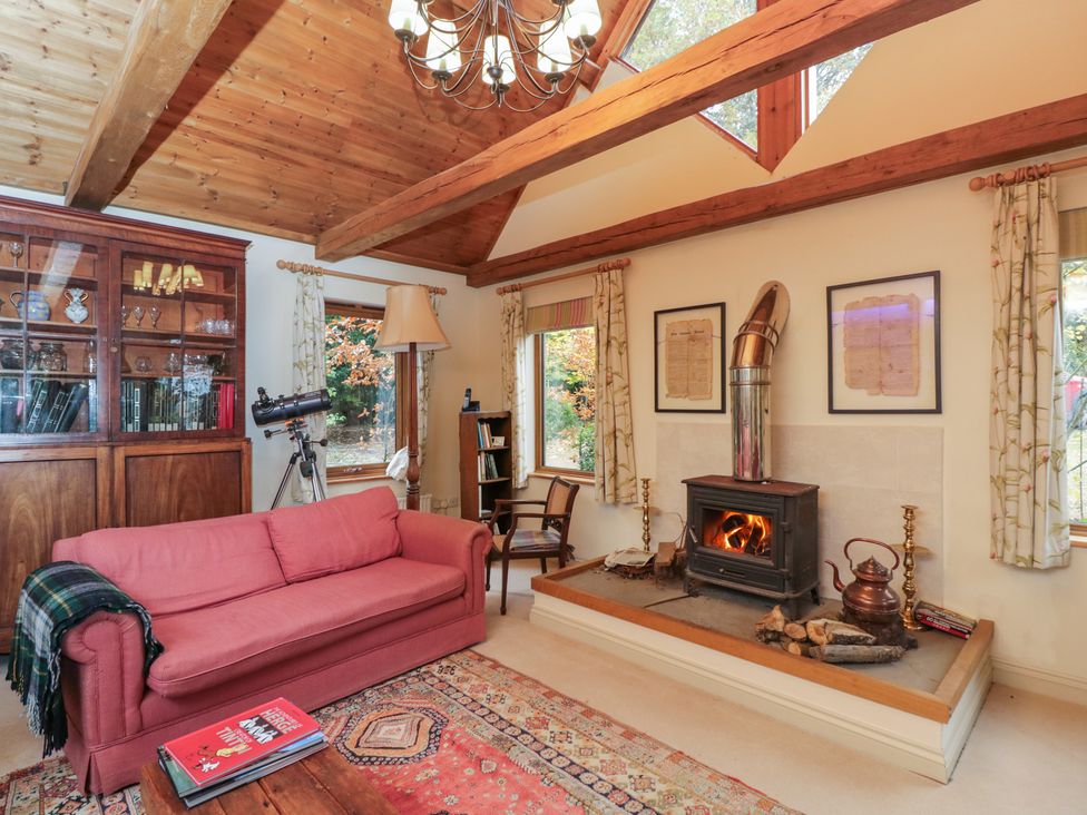 A living room with a fireplace and telescope at Gardeners Hill Annex 