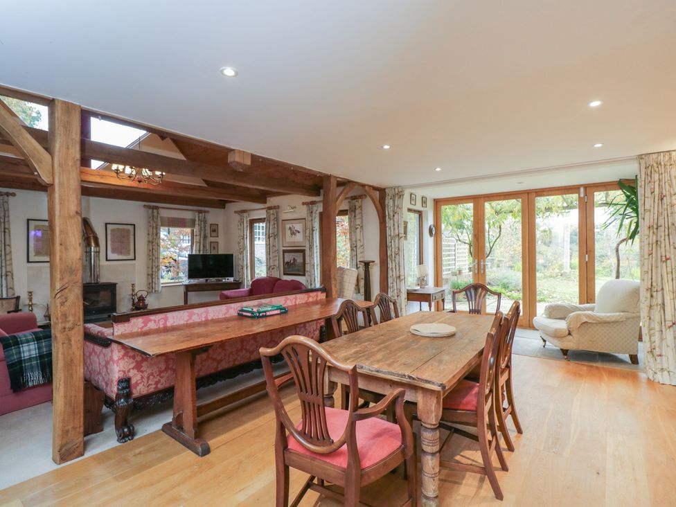 A dining area with a wooden table and chairs at Gardeners Hill Annex