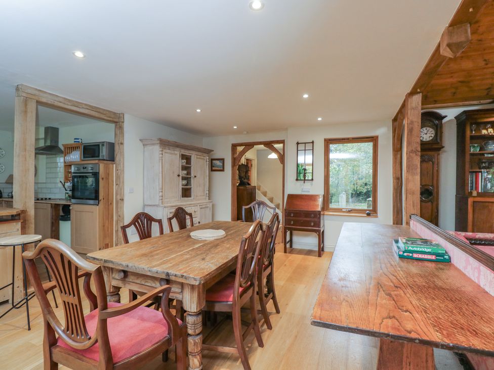 A dining room with a wooden table and chairs at Gardeners Hill Annex